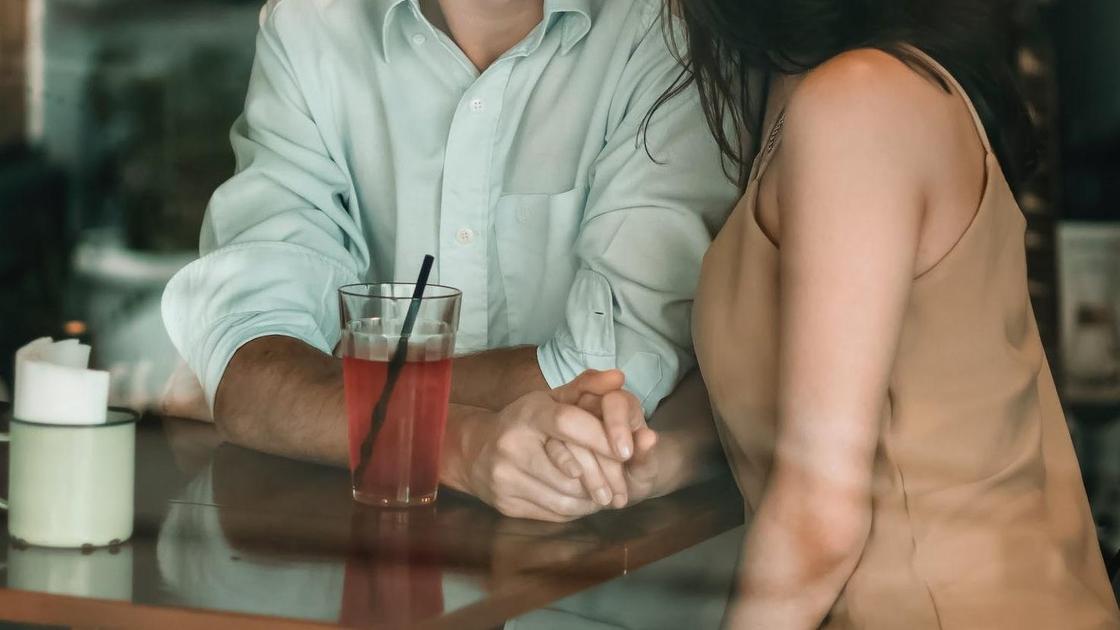 Чоловік з жінкою сидять за столом Мужчина с женщиной сидят за столом